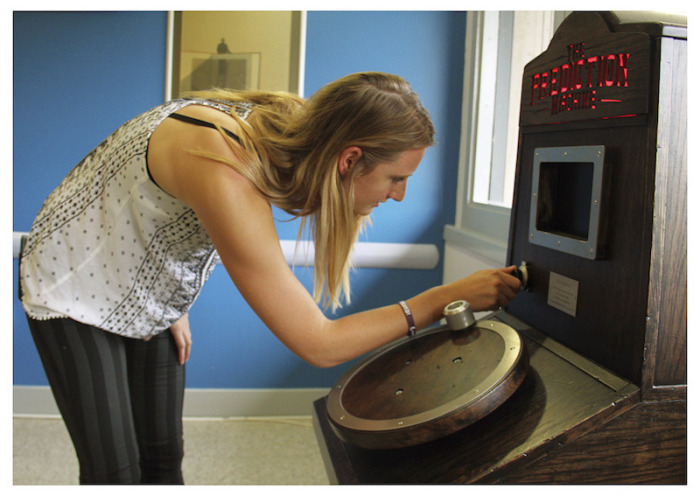 a woman turning the age dial on The Prediction Machine