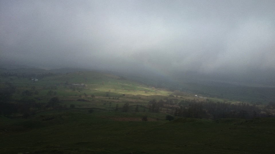 rainbow and clouds over the hills